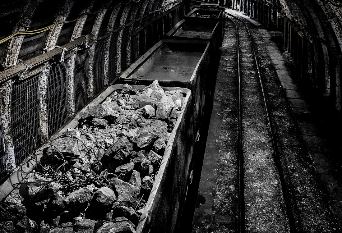 Dust suppression in mines of an underground coal mine with coal in rail wagon. 